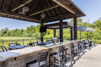 A bar with chairs and tables under a pavilion